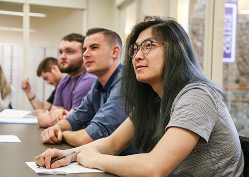 A Curry College student listens to a career advice presentation