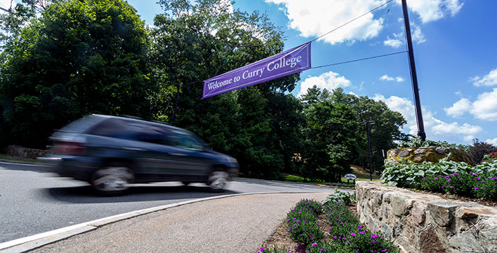 A car drives on the Curry campus