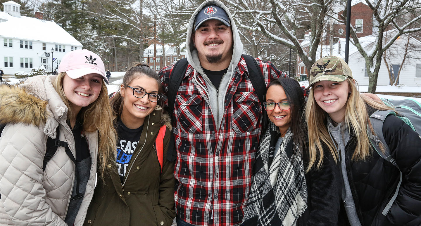 Students pose for a photo on a snowy Curry campus