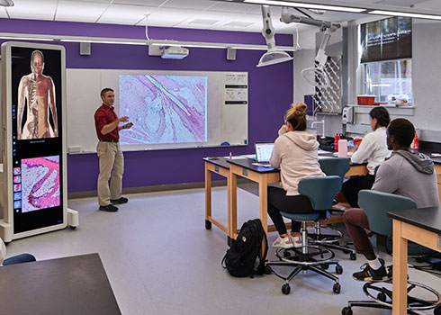 Students and faculty in a classroom in the Curry College Learning Commons