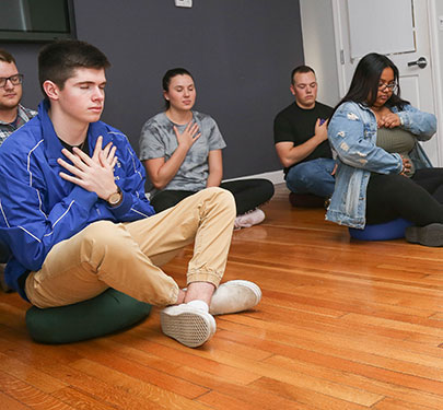 Students do Yoga in the Curry College Wellness Center