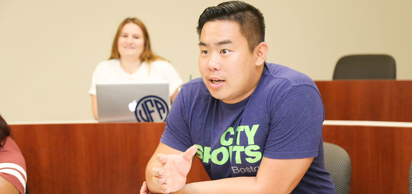 Student from China participates in a classroom discussion at Curry College
