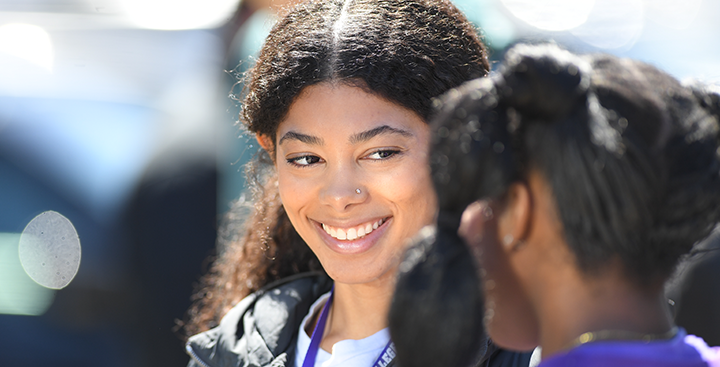 A Curry College student smiles with a friend