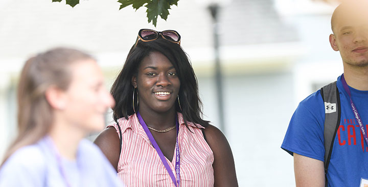 Student smiling for a photo on the Curry College campus