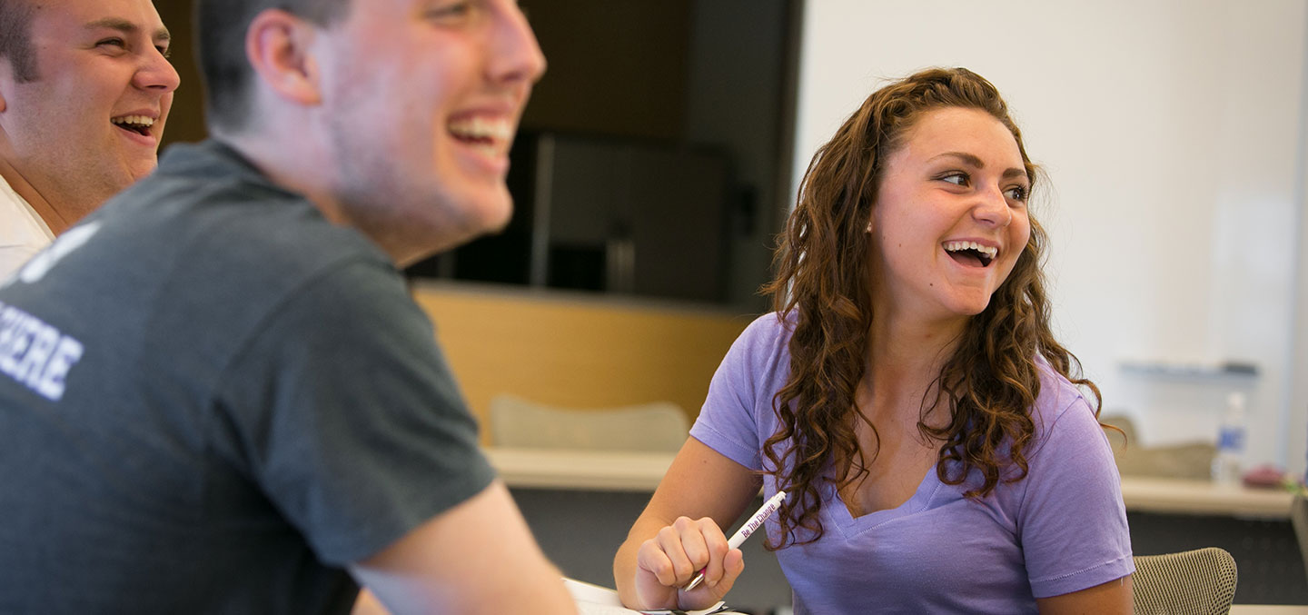 Students at Curry College in Class smiling