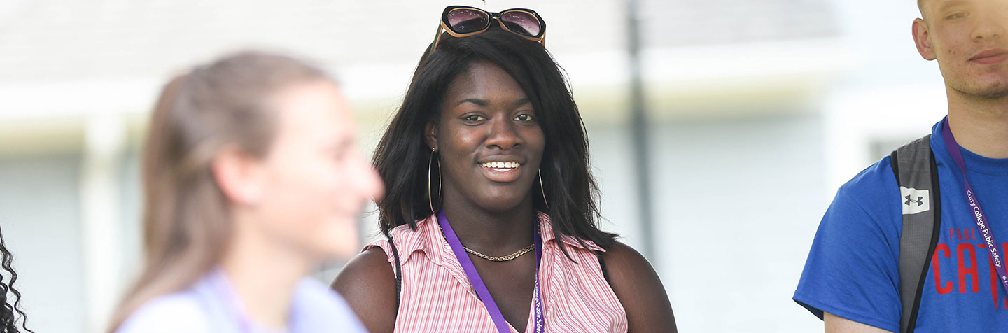 Students smiling on the quad during Senior Visit Days at Curry College