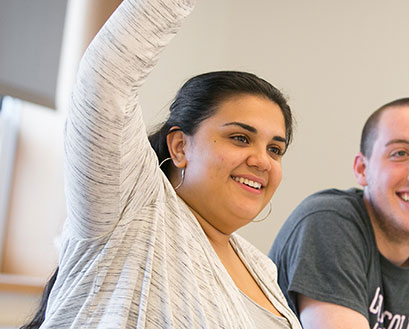 Curry College Student raising her hand in Class