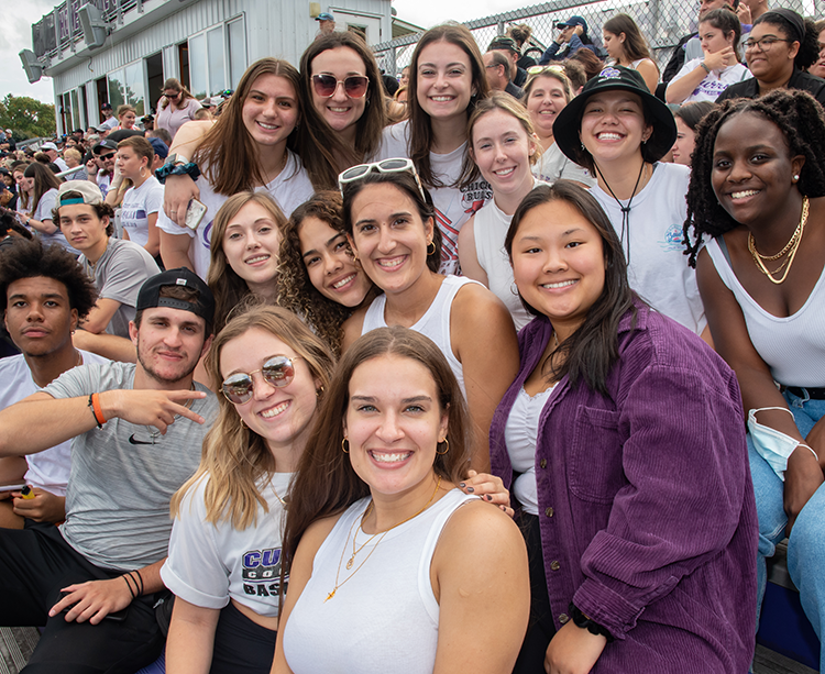 Curry College Alumni pose for a photo at Homecoming