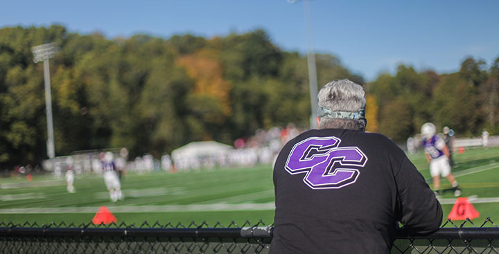 A Curry Alumnus watches a Colonels Athletics football game