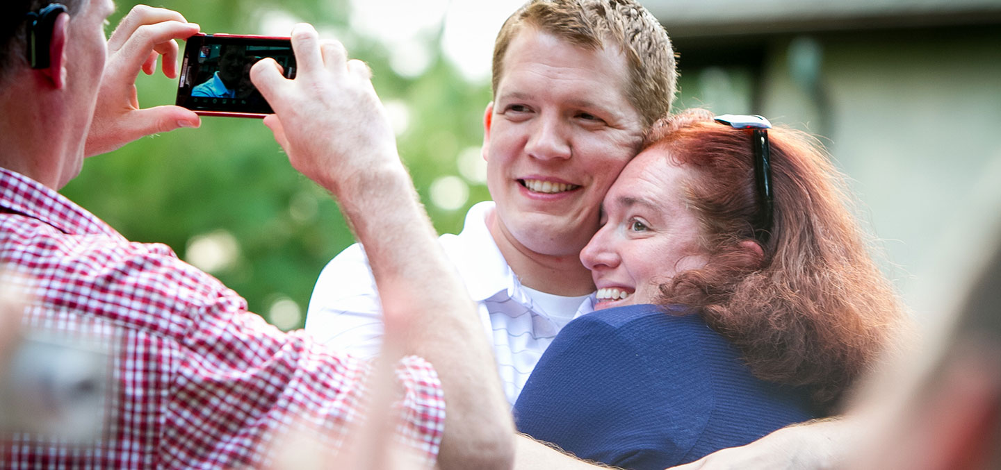 Curry College Alumni hug for a photo at a recent Class Reunion