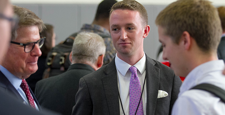 Alumni and faculty network at a Curry College event