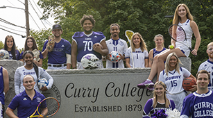 Curry College Athletes pose for a photo at the front gate
