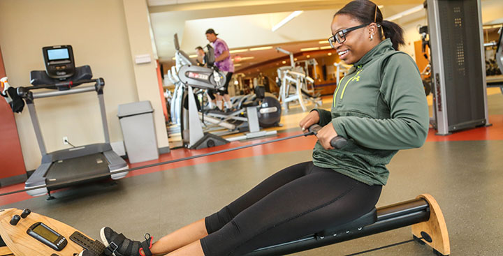 A student on the rowing machine at the Curry College Fitness Center