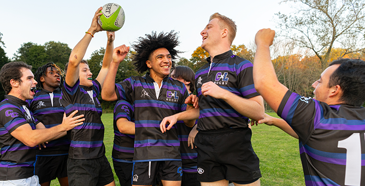 The Curry College Men's Rugby team celebrates