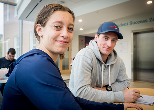 Students collaborating in the Curry College Learning Commons study area