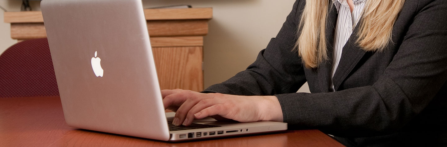 A Curry College Parent Accesses Digital Resources on her laptop