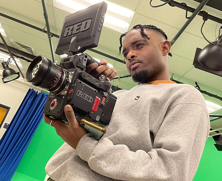 A communication student uses a RED Camera for film class