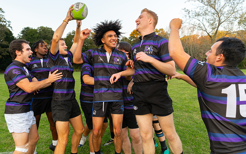 Curry College Men's Rubgy players celebrate