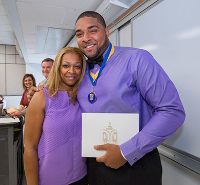 A Lambda Alpha member poses for a photo with his mom