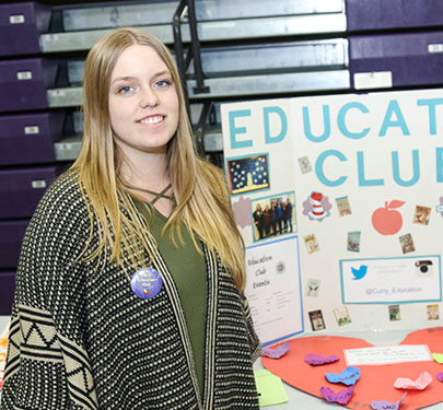 A Curry College Education Club student member poses for a photo