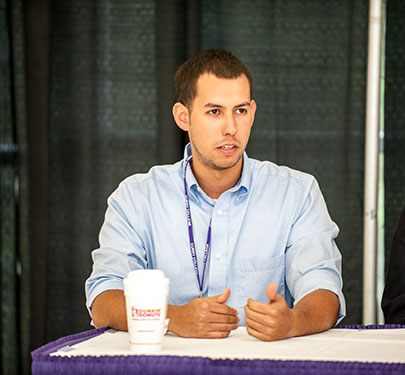 Alumni speaks at podium