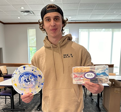 Business Students Association member shows off his colorful work