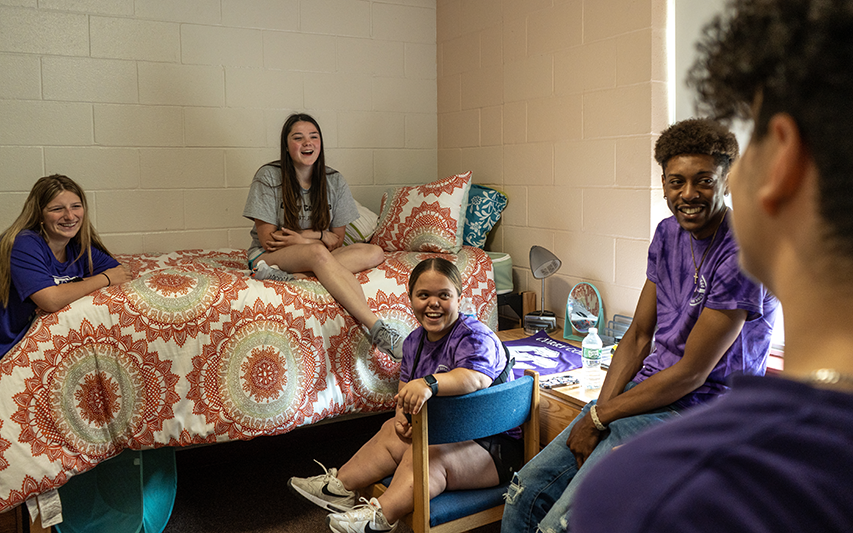 Students laughing in their residence hall