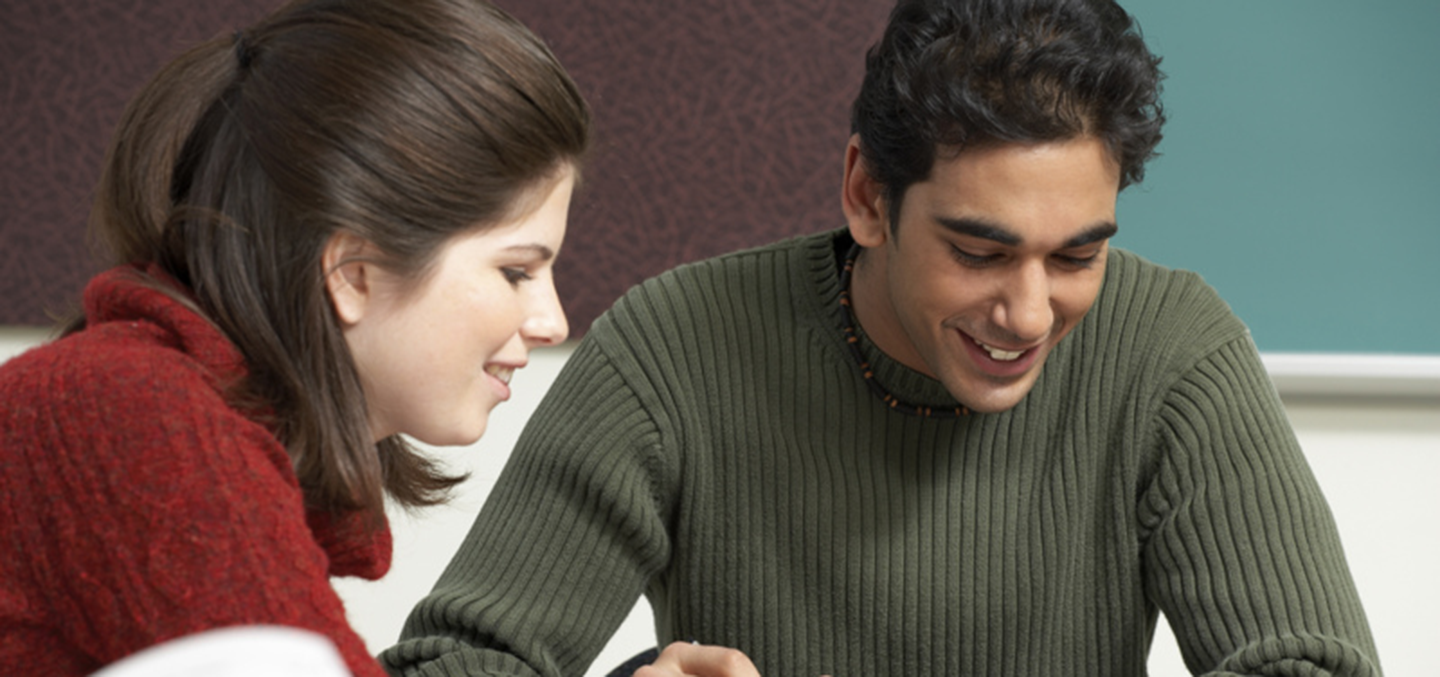 A student gets instruction from a fellow student