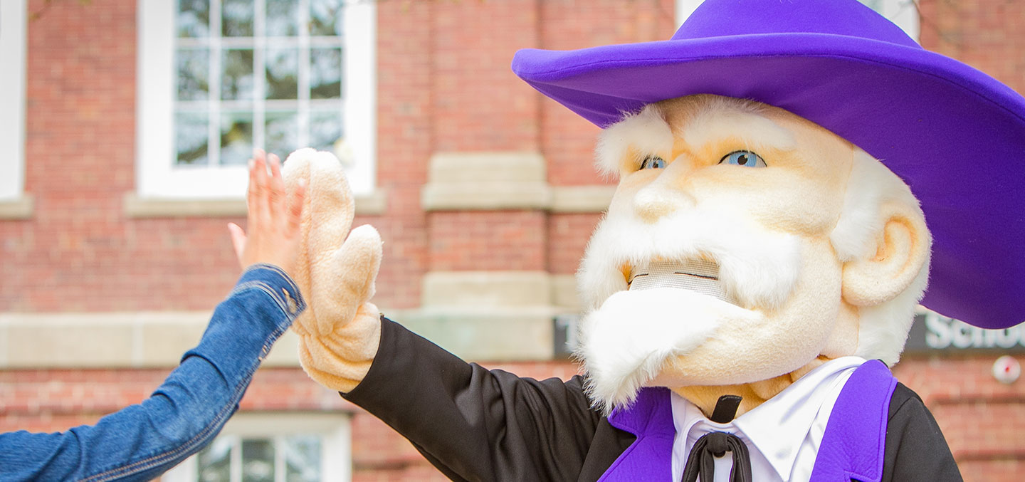 The Colonel hi-fiving a student