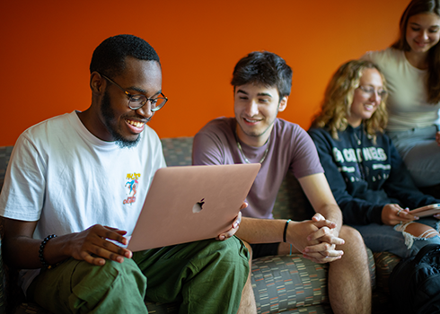 Students search for resources on a laptop