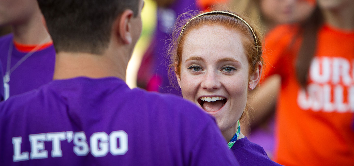 Curry student smiles at the camera during welcome week