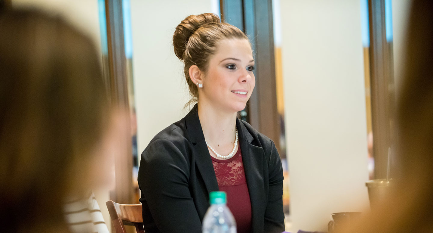 A student speaks to an audience