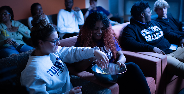 Curry College students have a movie night with popcorn