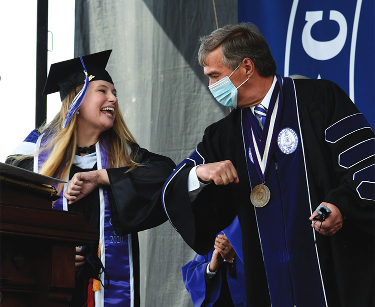 Curry Magazine Cover - Commencement 2021 Ceremony elbow bump