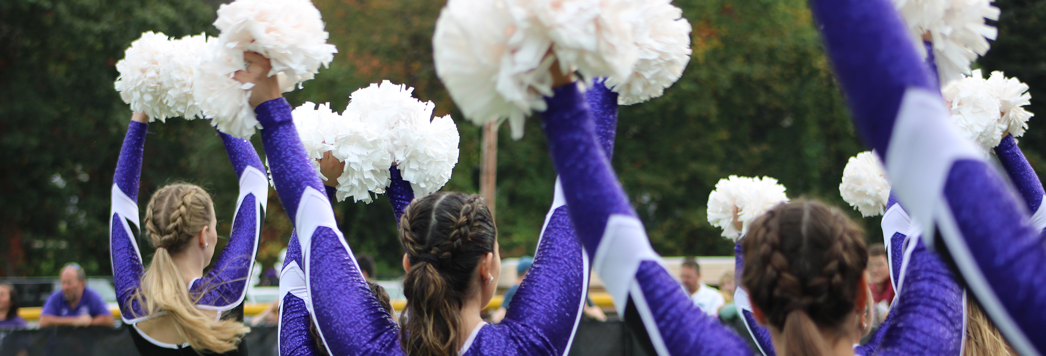 Curry College cheerleaders perform for the Homecoming crowd
