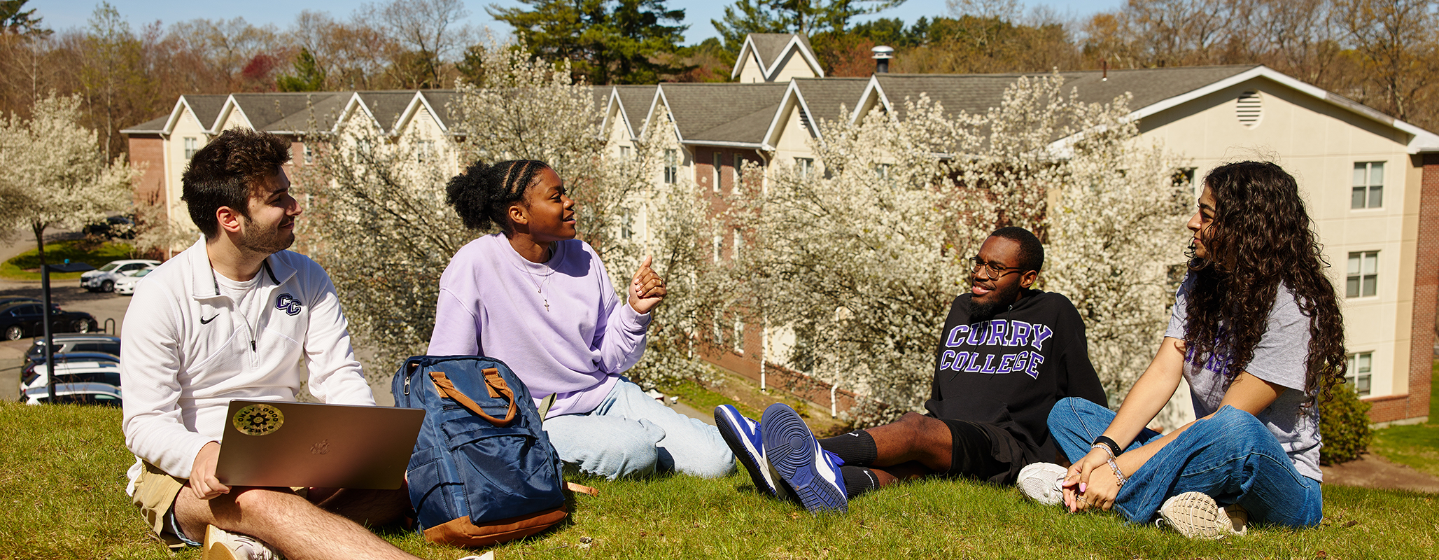Students collaborate on a project on Suites Hill at Curry College